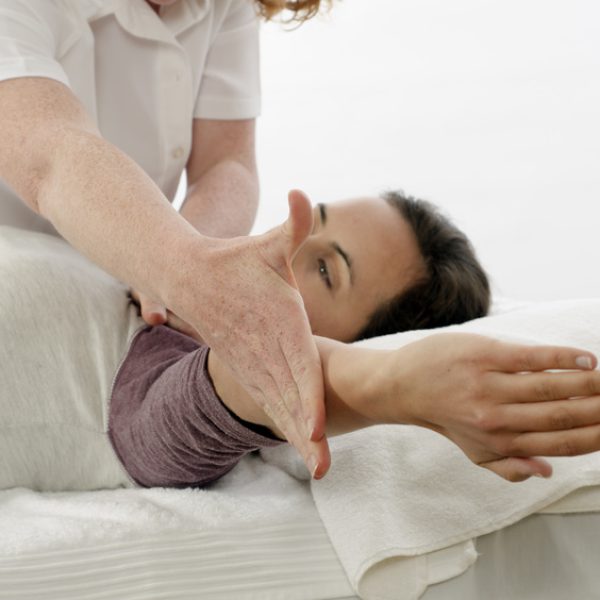 Kinesiologist treating Trapezius Kinesiologist or physiotherapist treating Trapezius